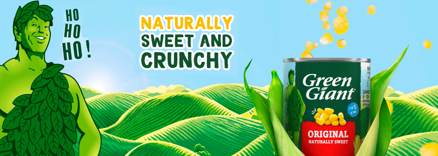 Green Giant mascot, cornfield background, can of Green Giant corn, text reads "Naturally Sweet and Crunchy.